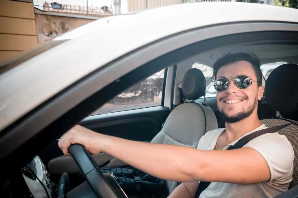 Driver seated in a car on a sunny day